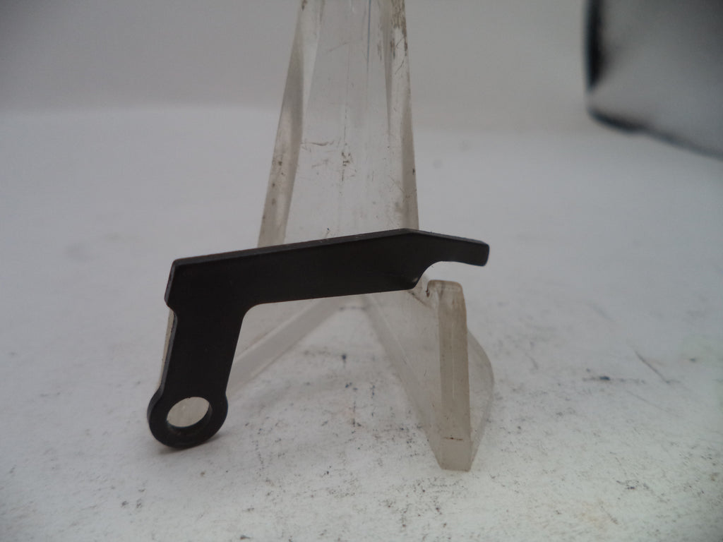 Metal bracket with a black component on a white surface
