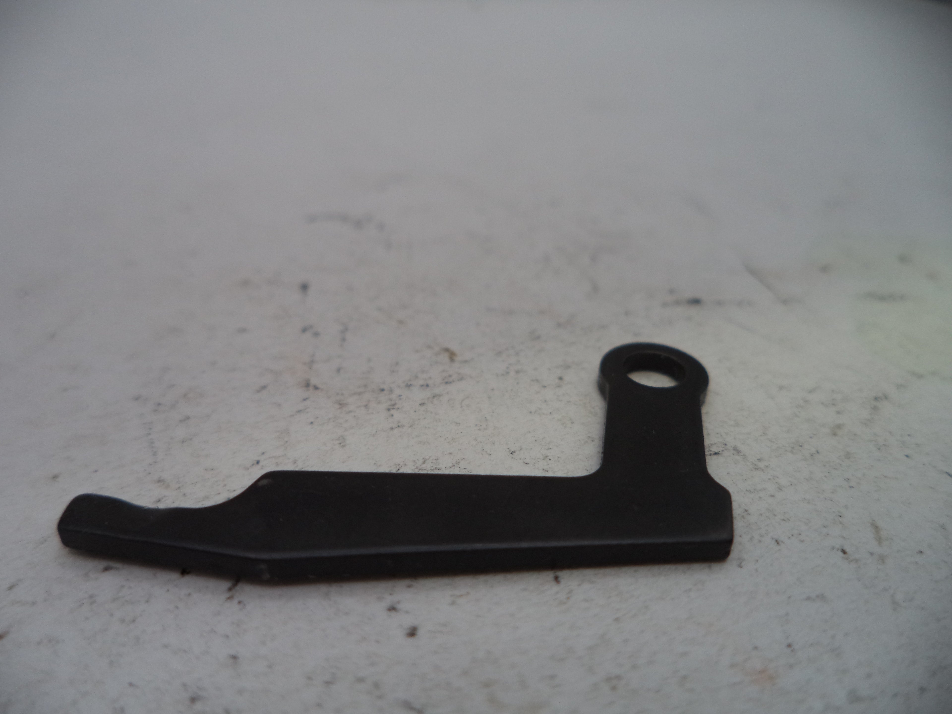 Black metal lever on a textured white surface