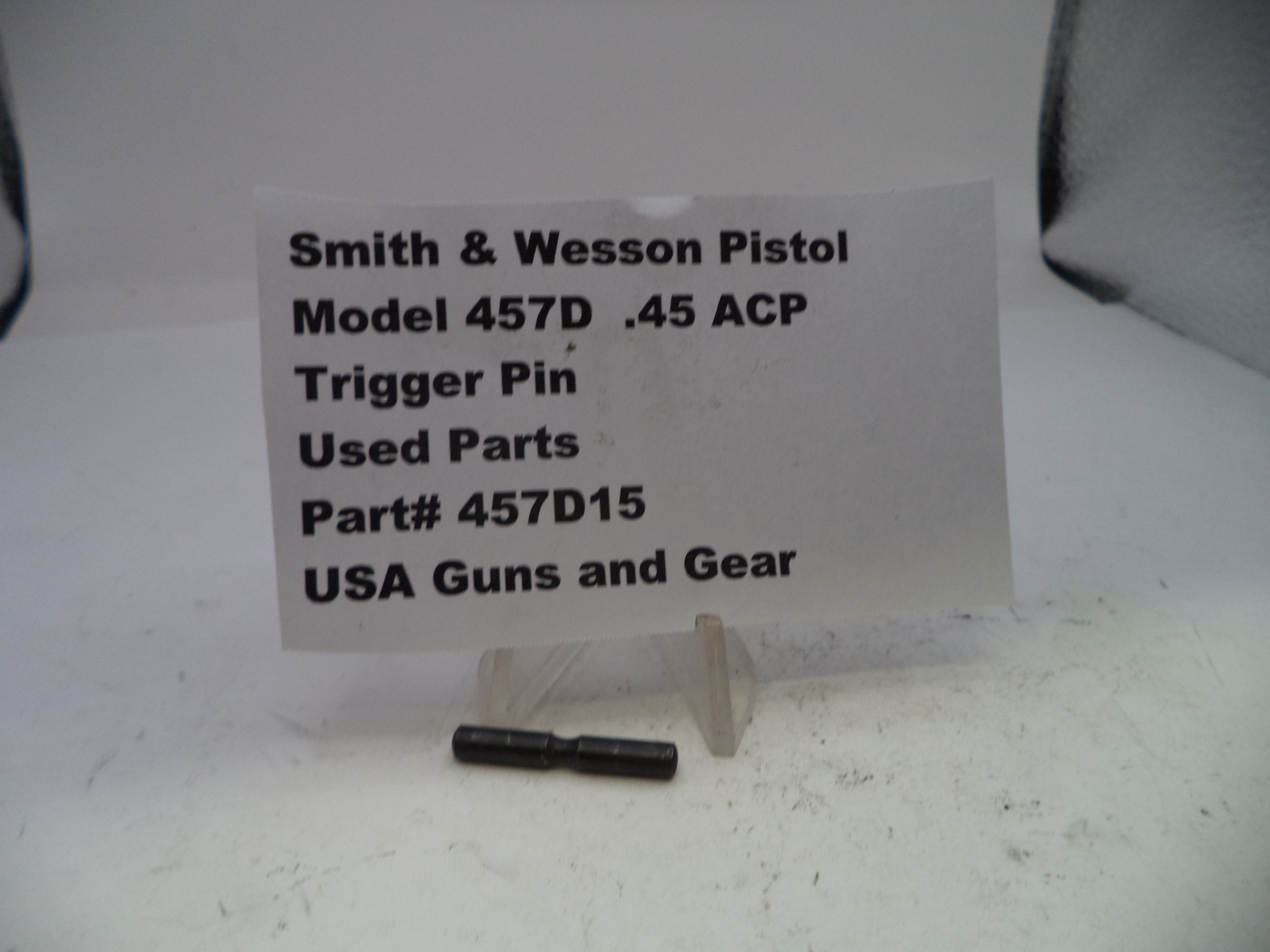 Smith & Wesson pistol trigger pin with a label on a white background