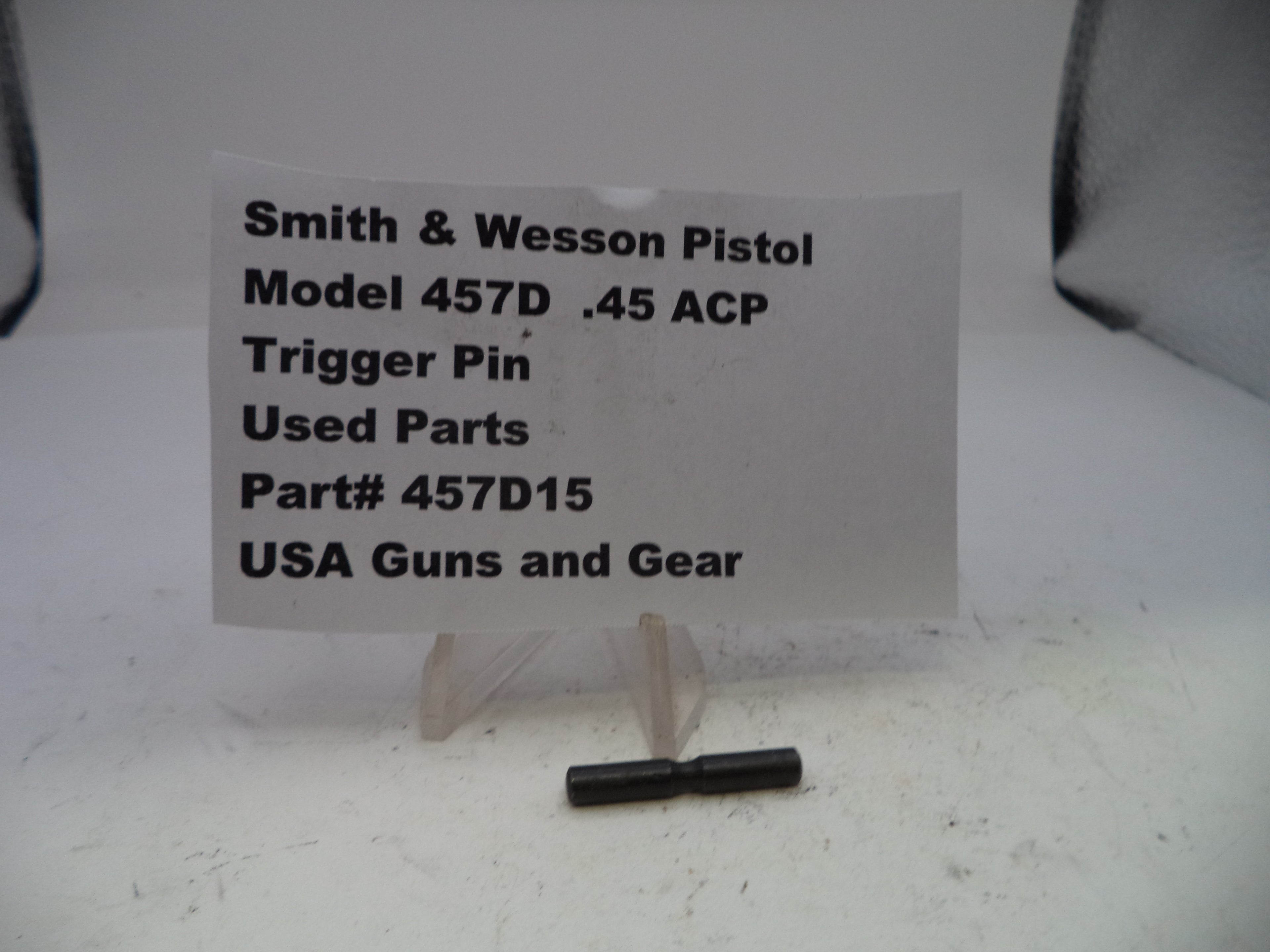 Trigger pin for Smith & Wesson Pistol Model 457D .45 ACP with a label on a white background