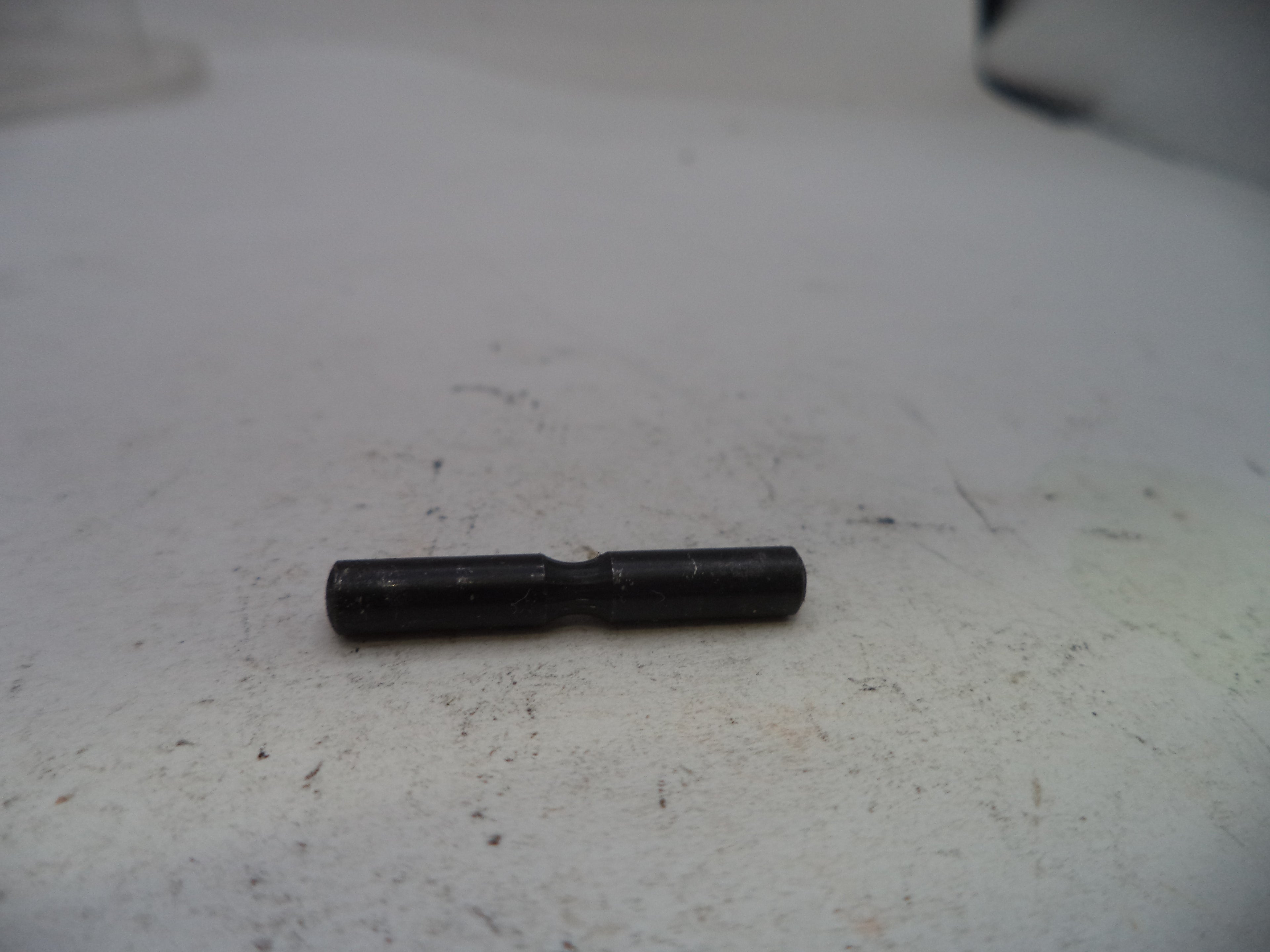 Black cylindrical object on a white surface