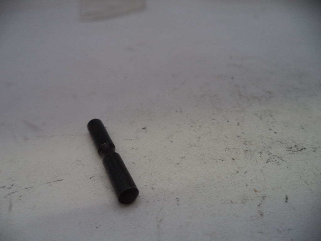 Small black cylindrical object on a white surface with visible scratches