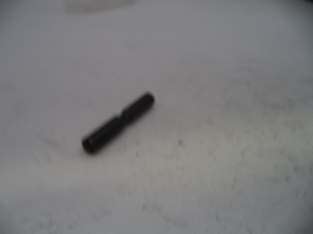 Black cylindrical object on a light gray surface