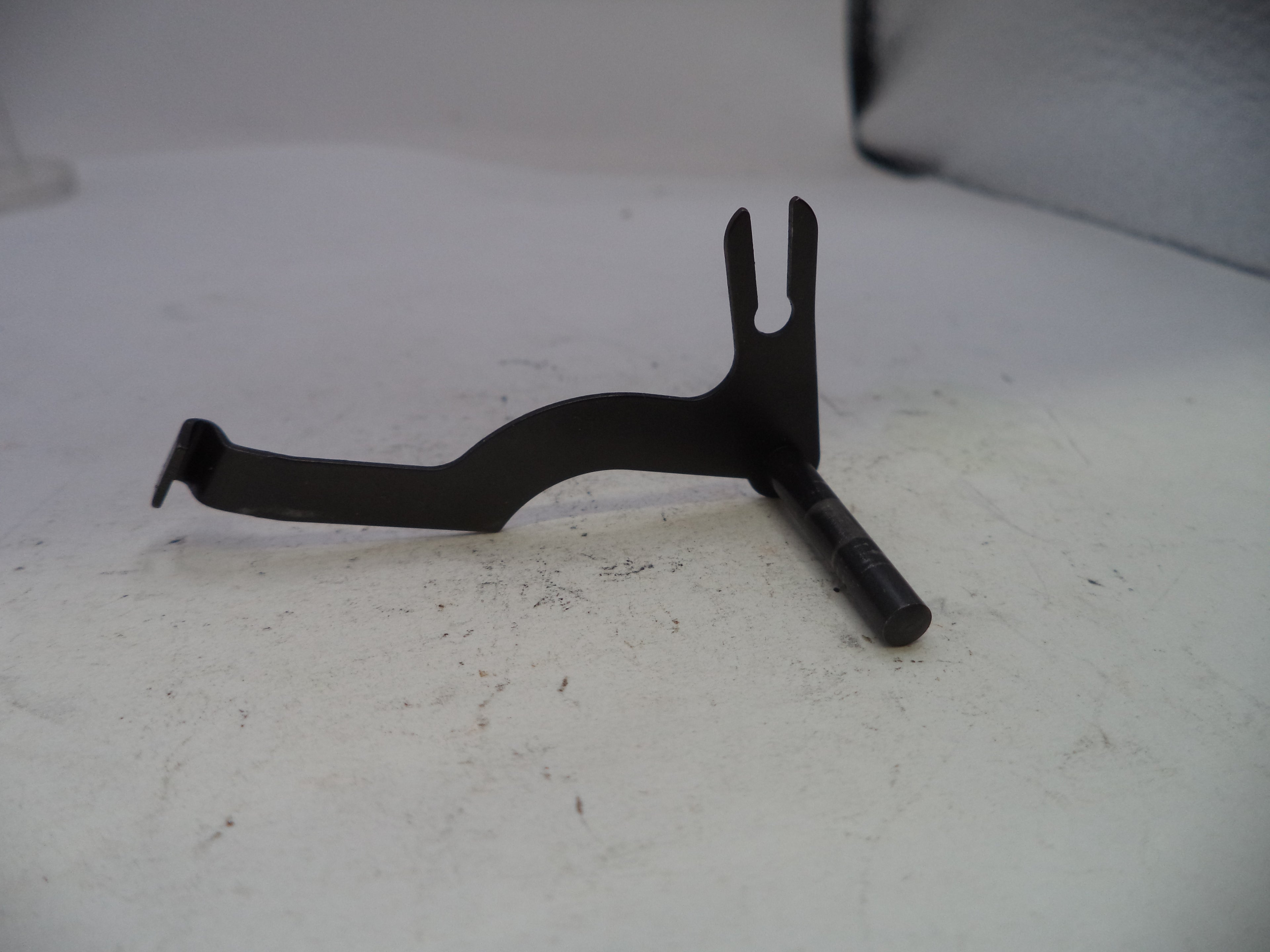 Black metal tool on a white surface