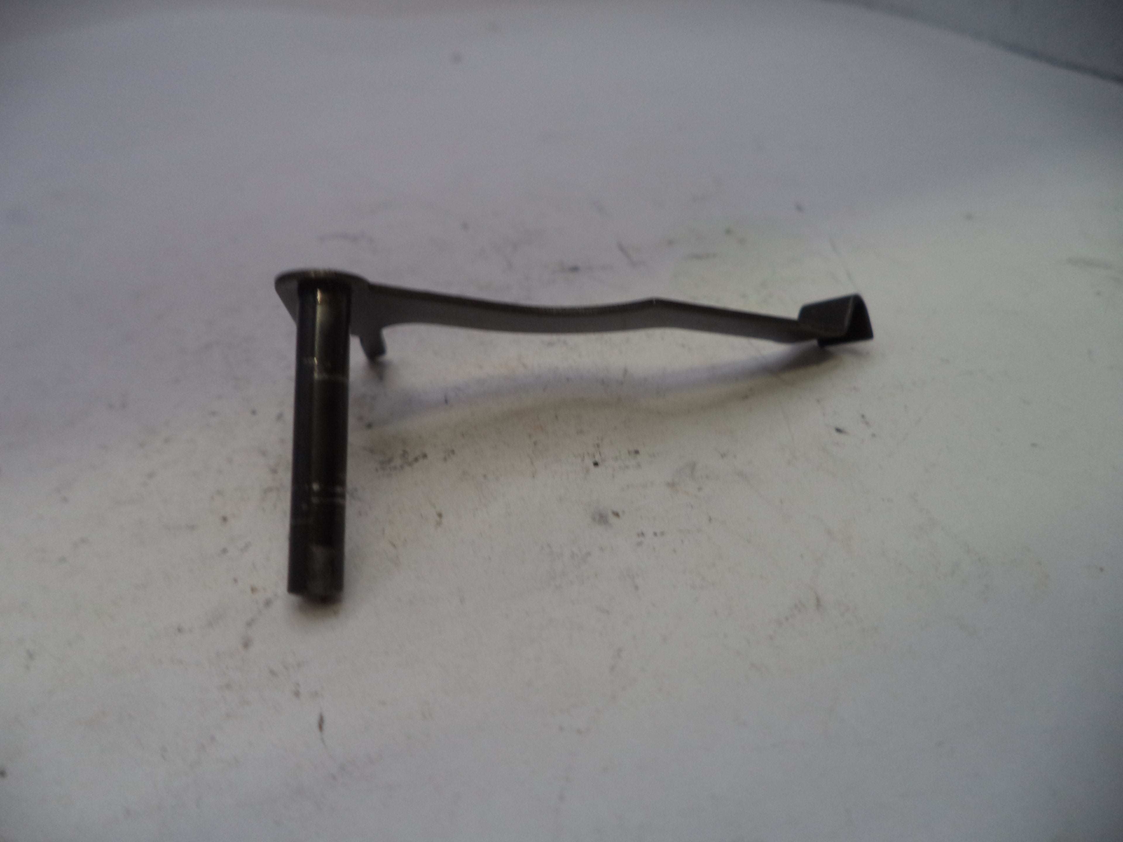 Black metal bracket on a white surface