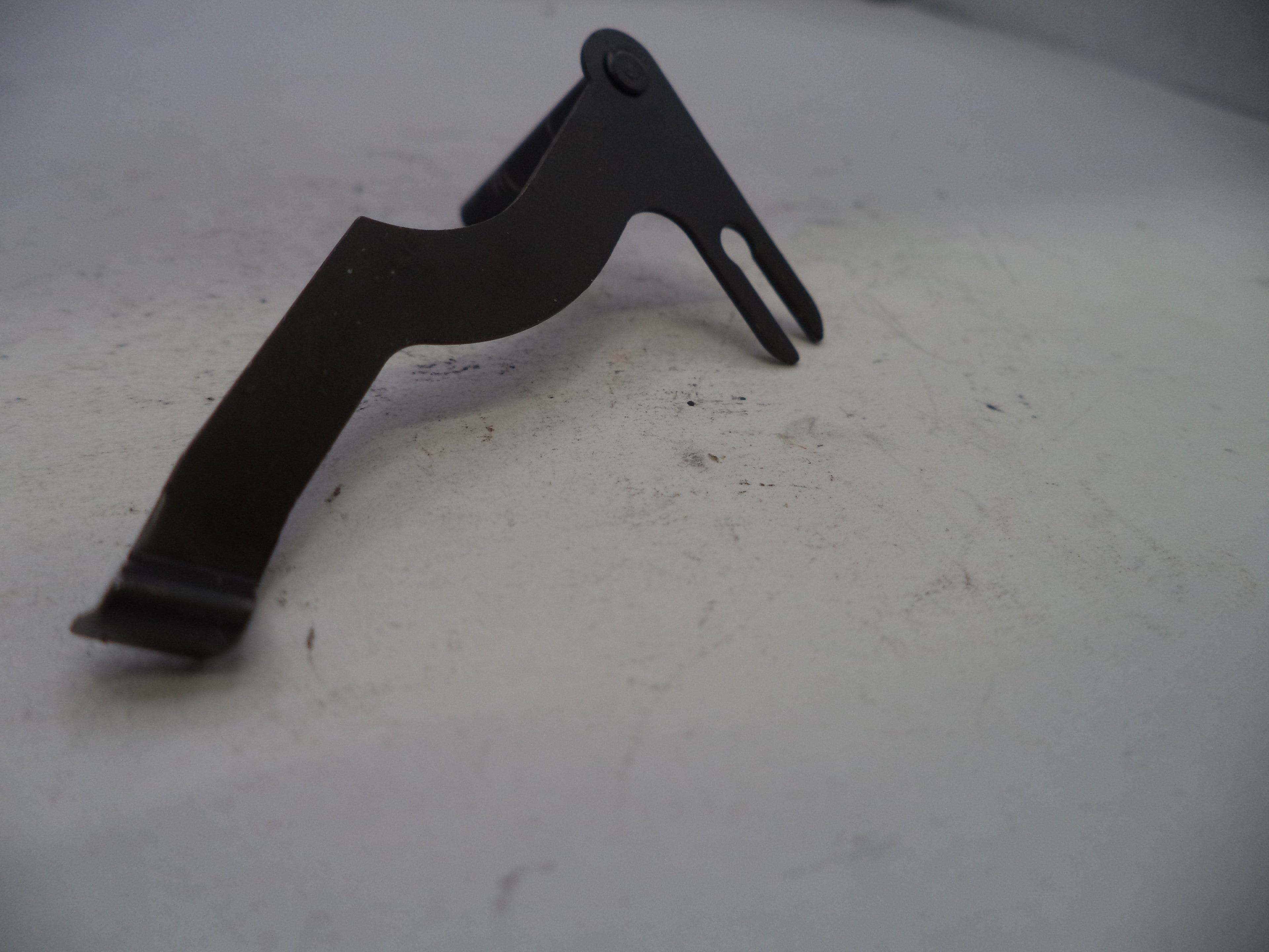 Black metal bracket on a white surface