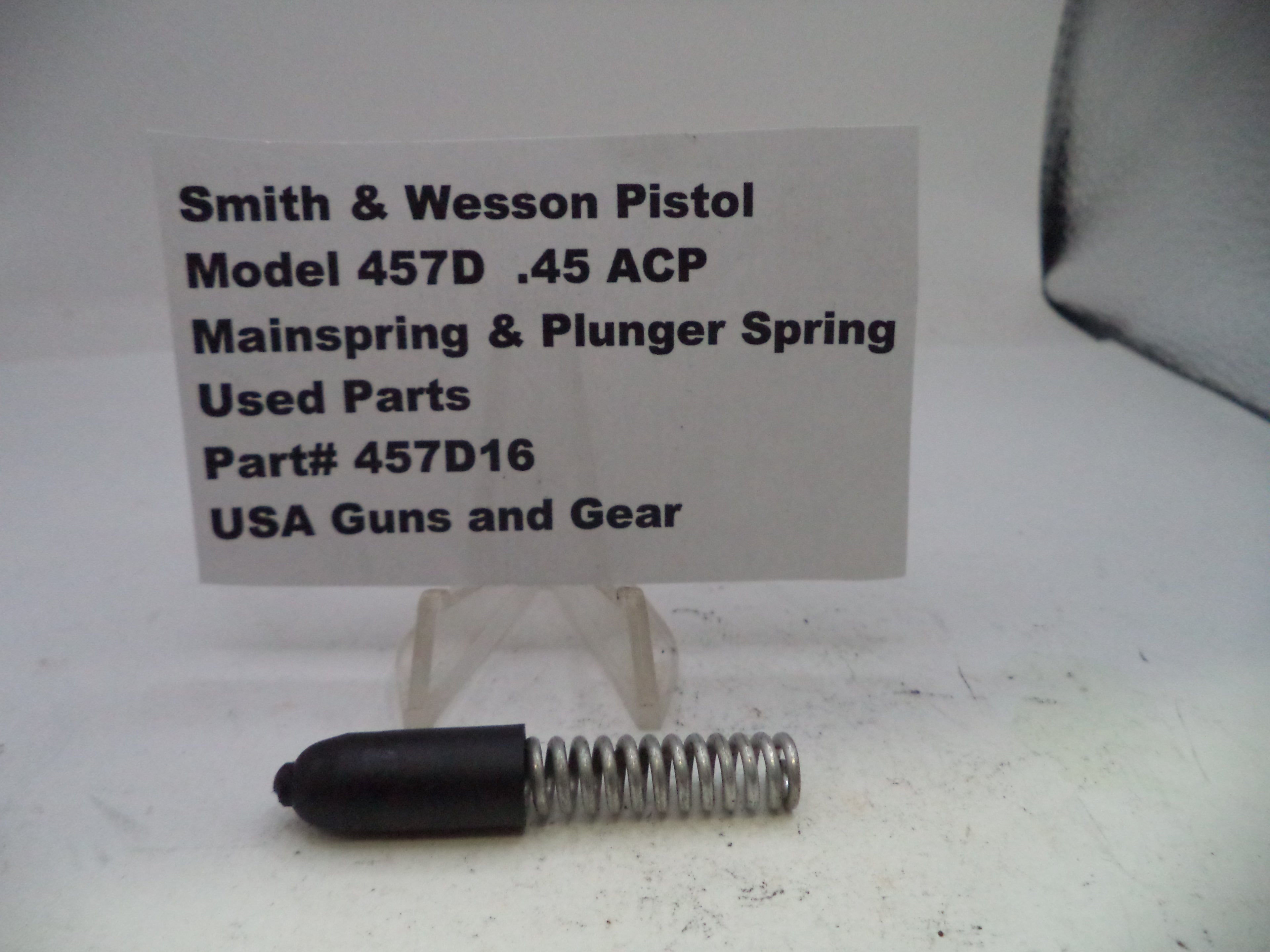 Smith & Wesson pistol mainspring and plunger spring with a label on a white background