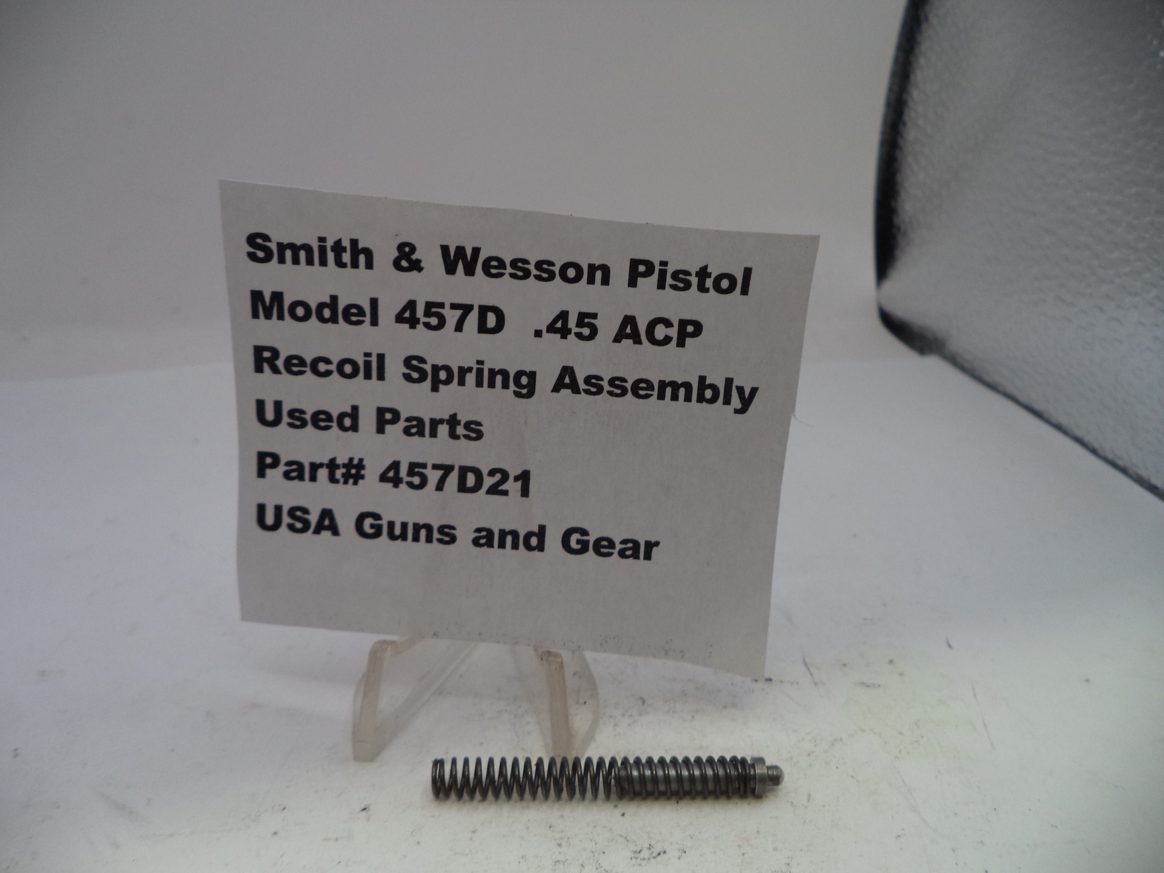 Smith & Wesson pistol recoil spring assembly with a label on a white background