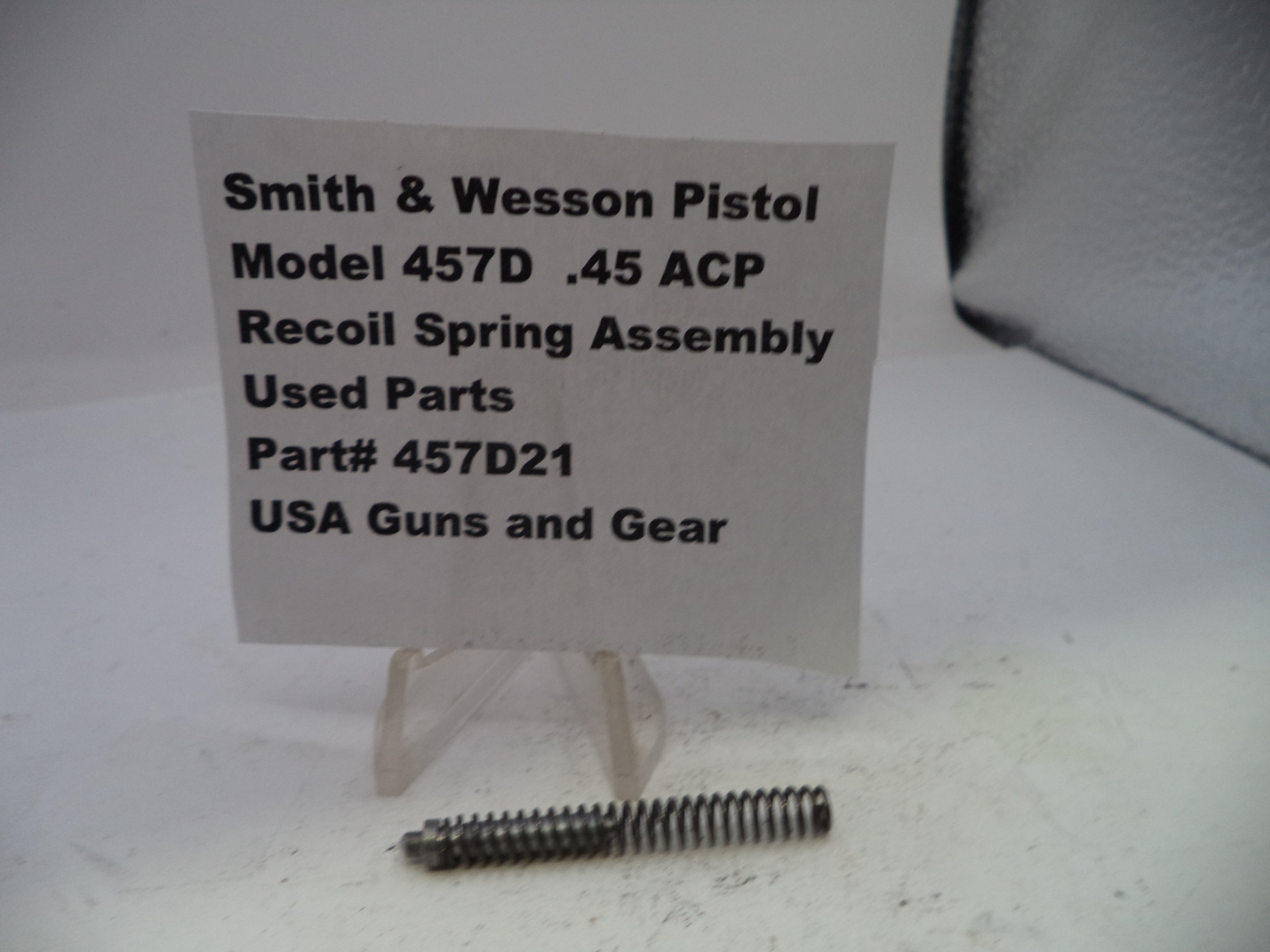 Smith & Wesson Pistol recoil spring assembly with a label on a white background