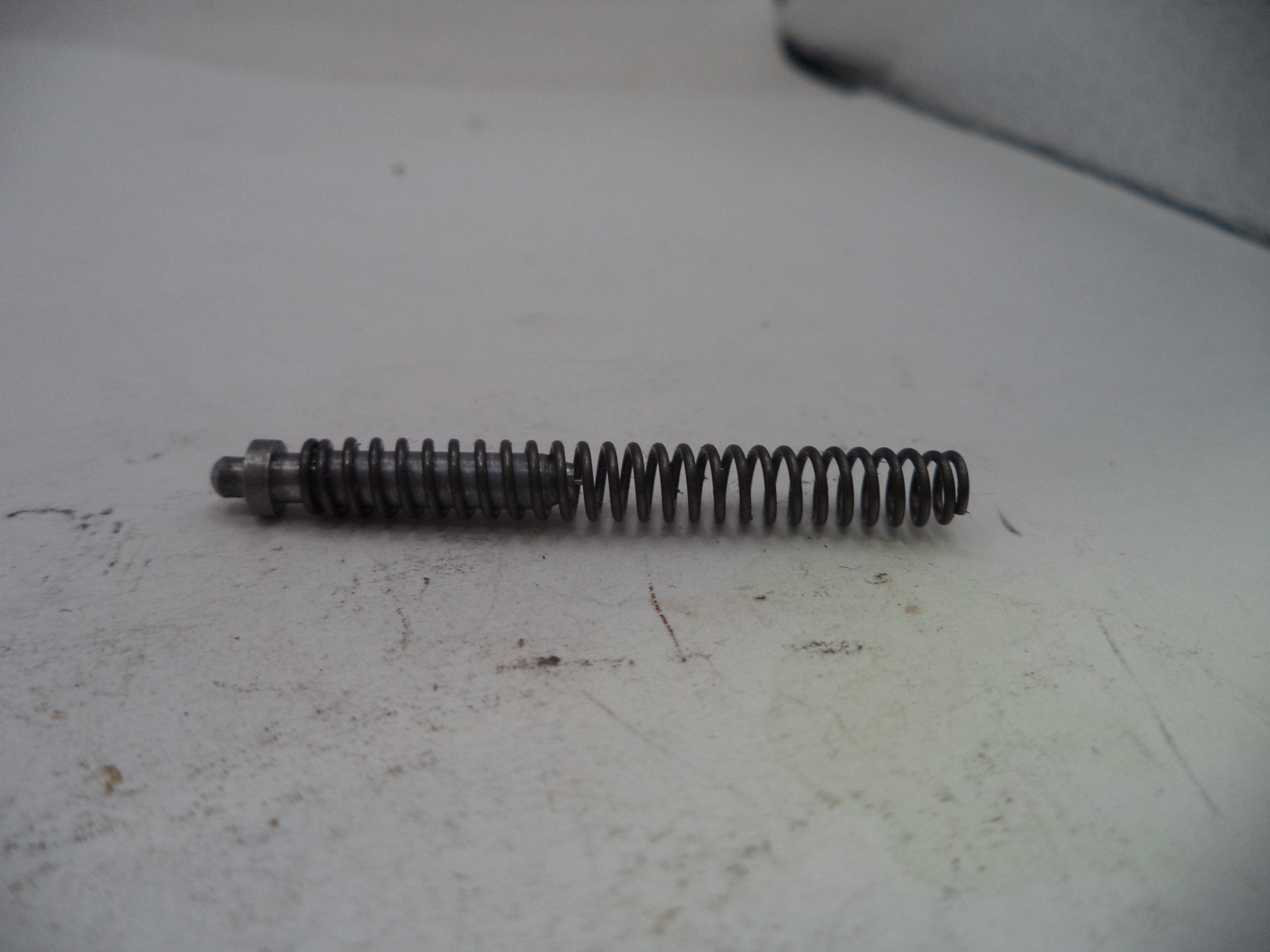 Metal spring on a white surface