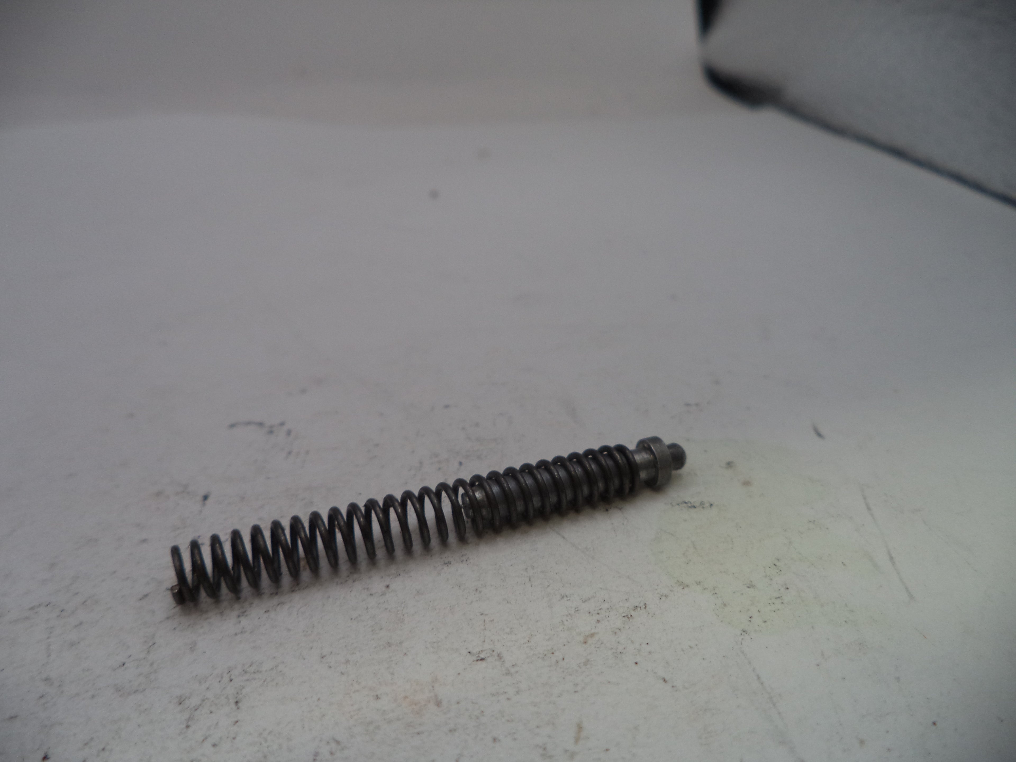 Coiled spring on a white surface