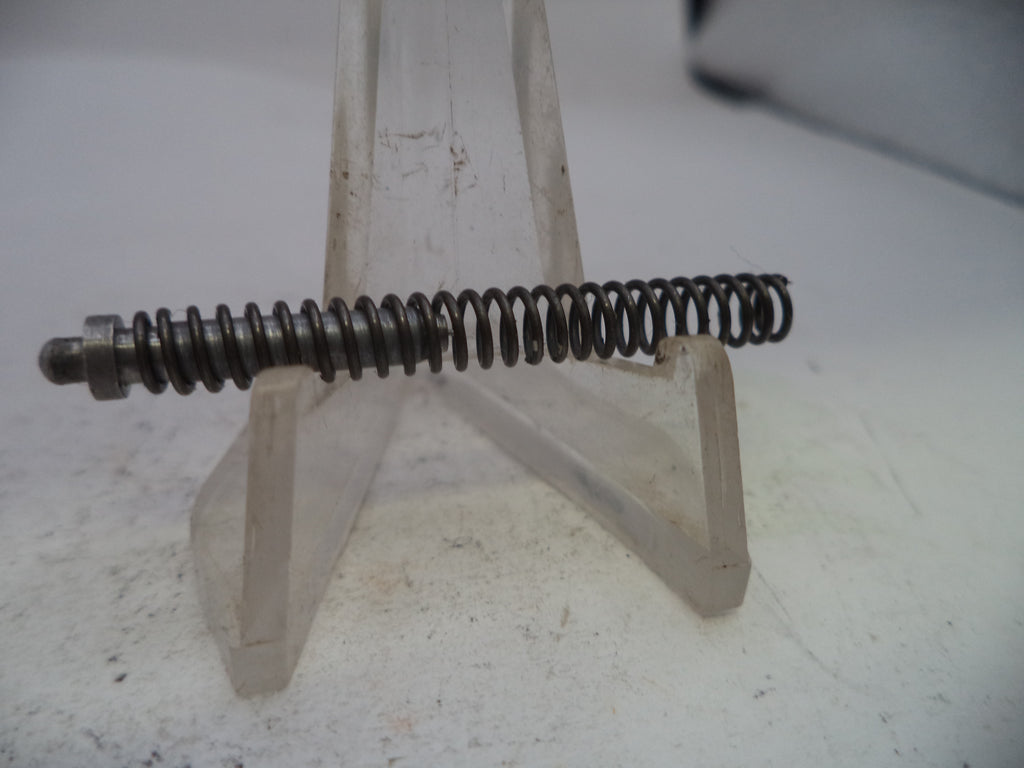 Metal spring on a stand against a white background