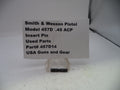 Smith & Wesson pistol part with label on a white background