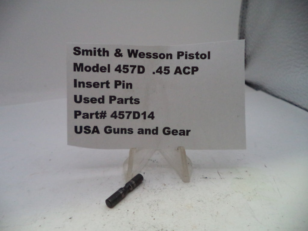 Smith & Wesson pistol part with a label on a white background