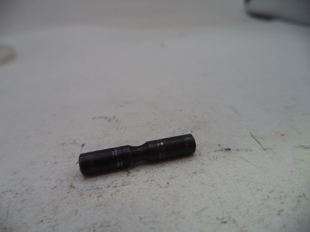 Black cylindrical object on a textured white surface