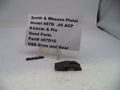 Smith & Wesson pistol parts on a white surface with a label.