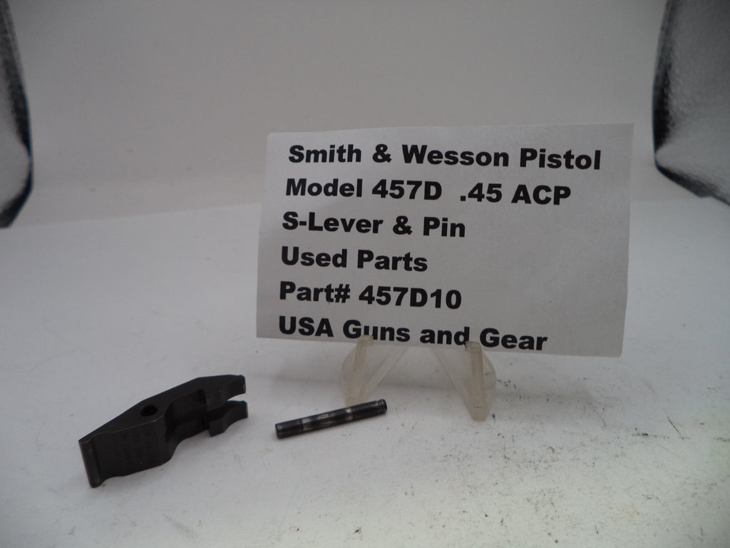 Smith & Wesson pistol parts on a white background with a label.