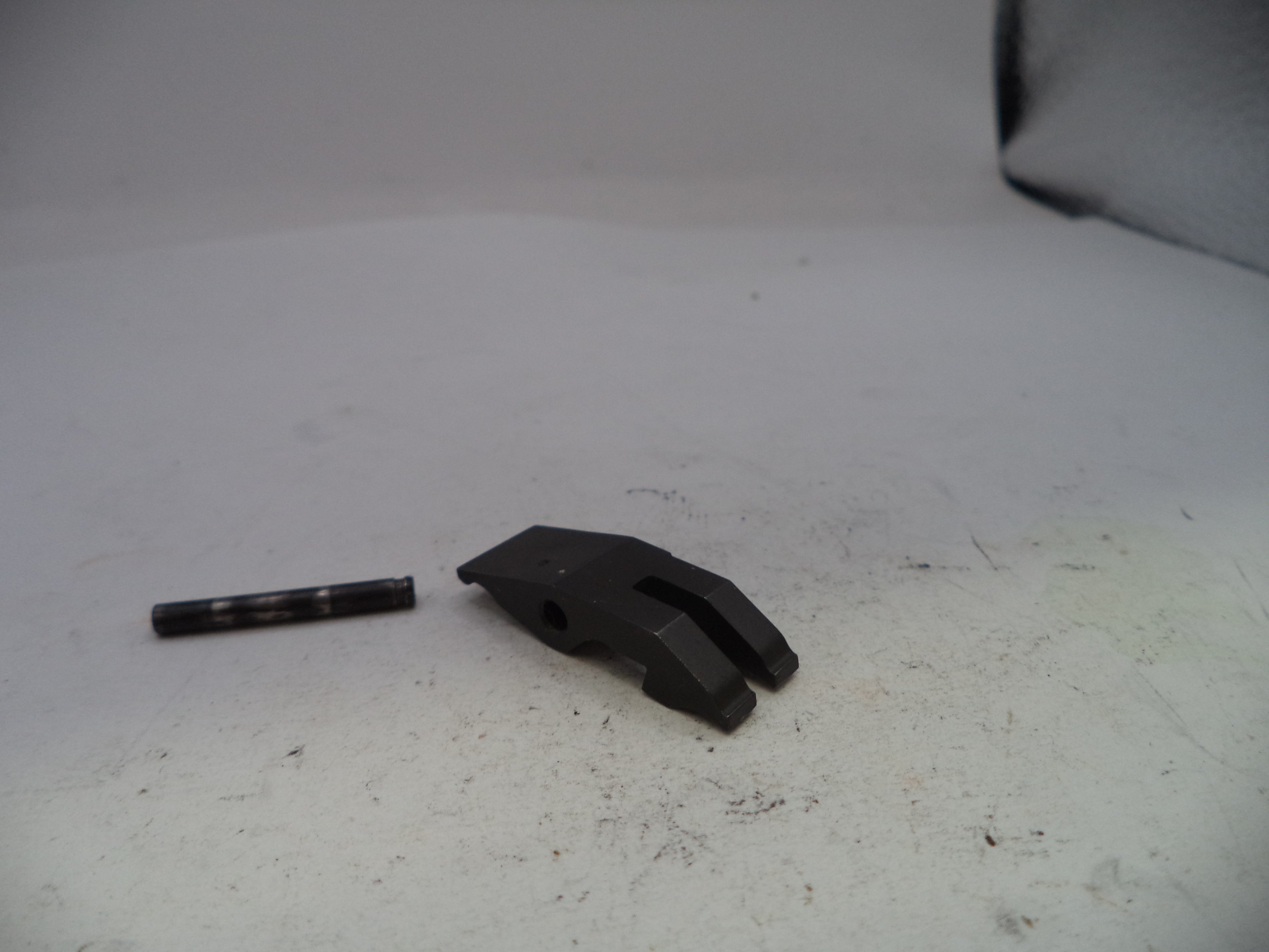 Two black metal components on a white surface