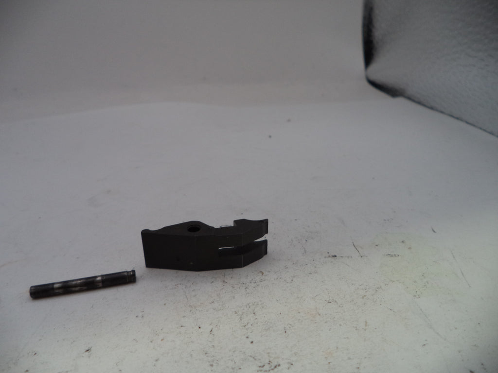 Two black mechanical parts on a white surface