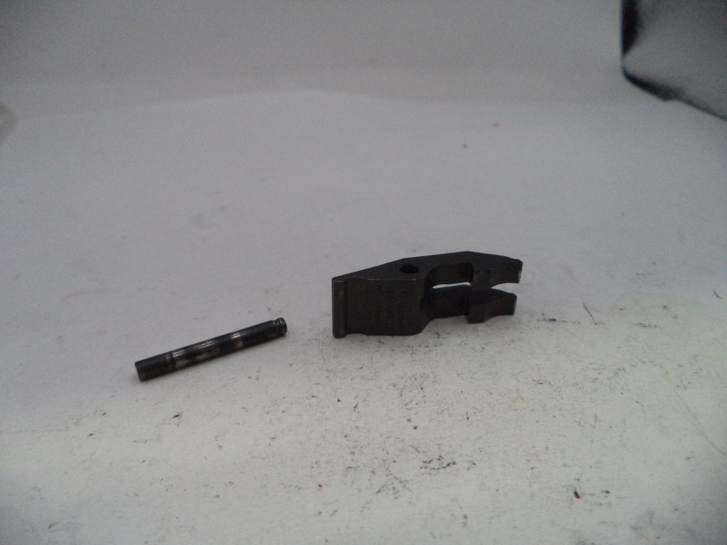 Two black metal components on a white surface