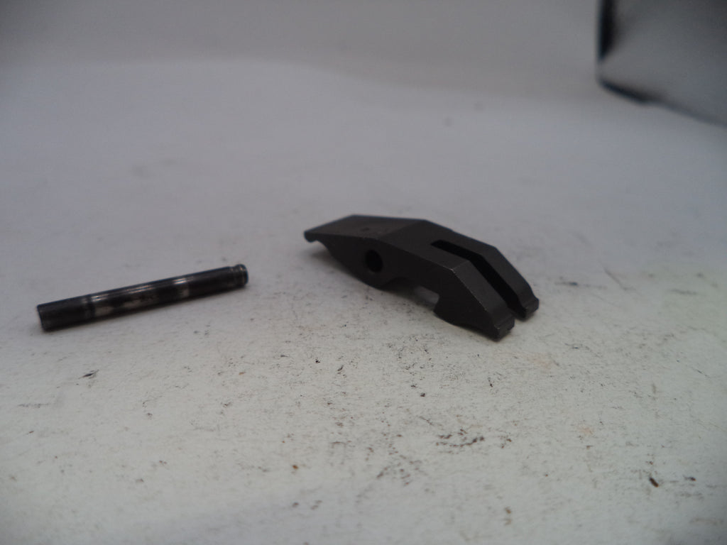 Two black mechanical parts on a white surface