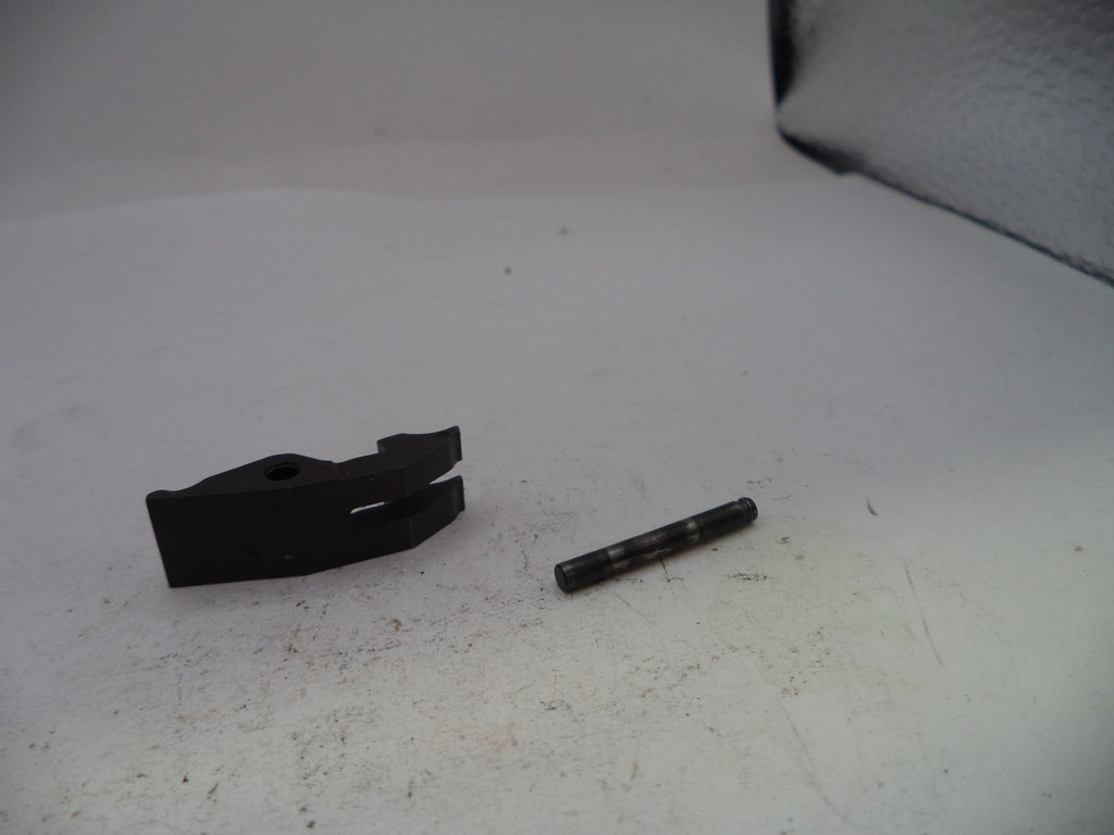 Two black mechanical parts on a white surface