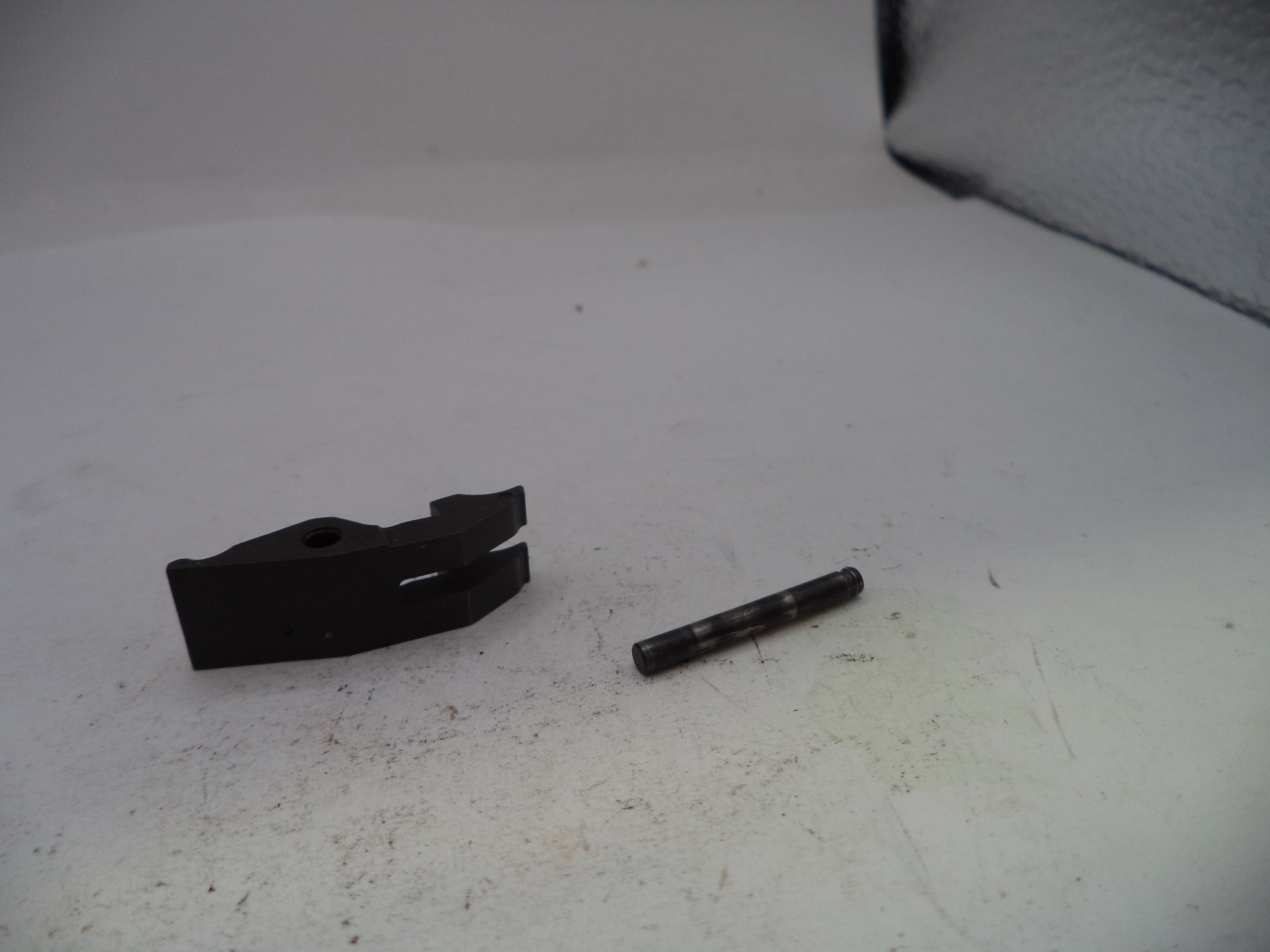 Two black mechanical parts on a white surface