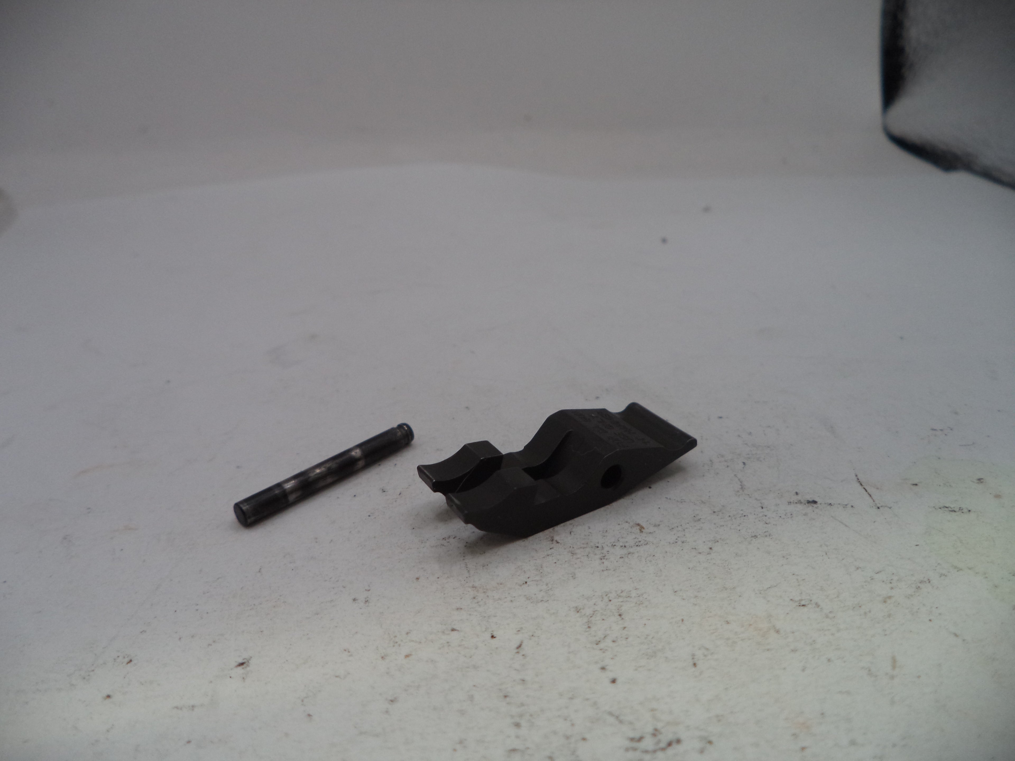 Two black metal components on a white surface
