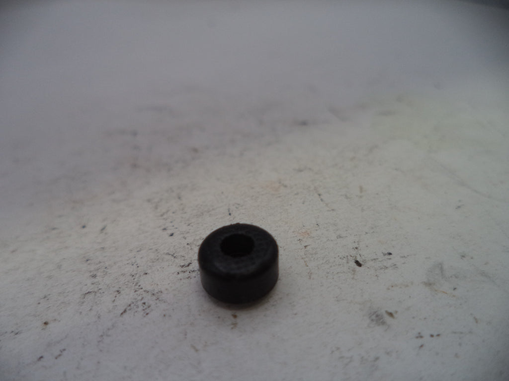 Black rubber bushing on a textured white surface