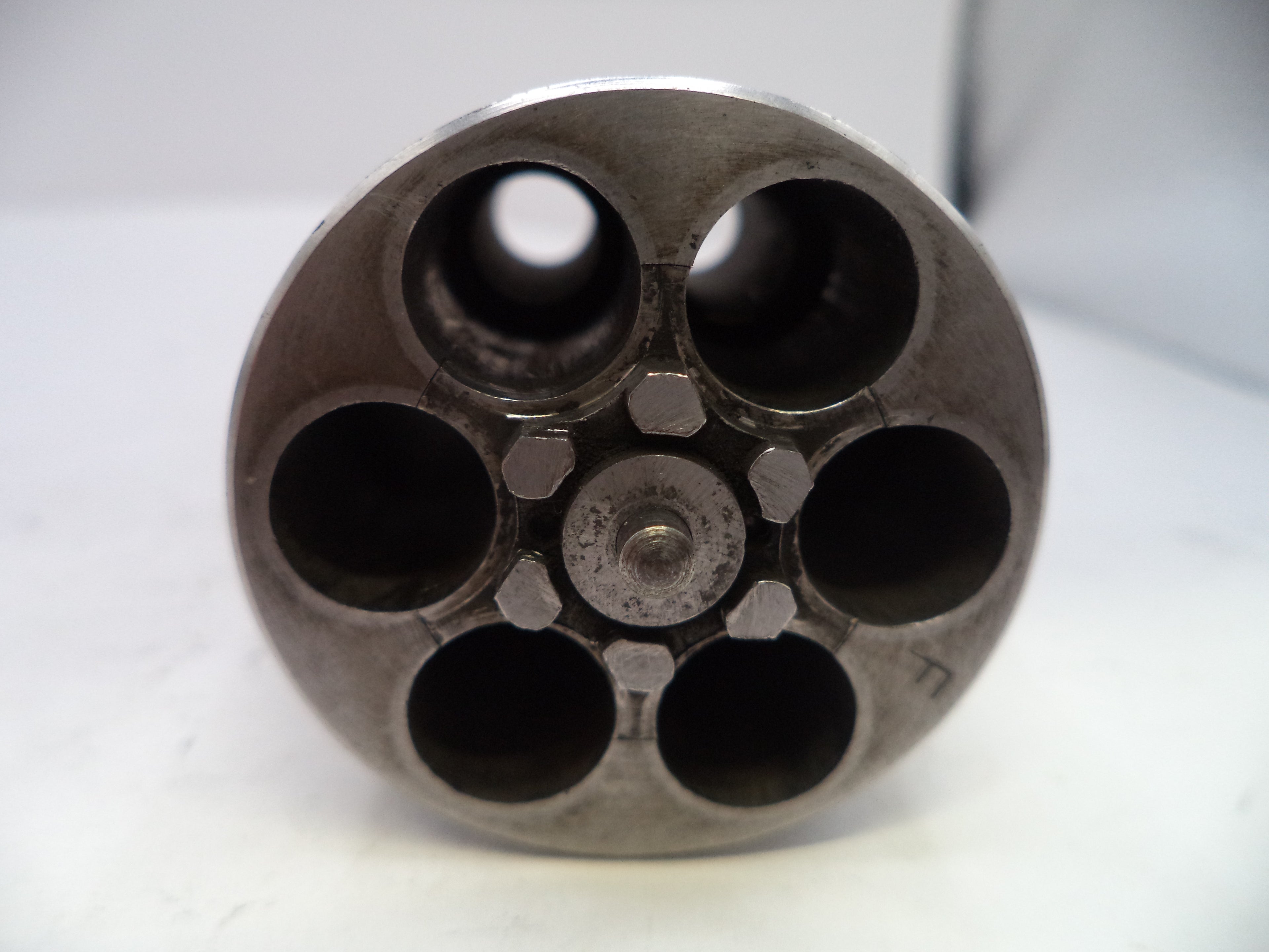 Close-up of a gun barrel with multiple chambers on a white background