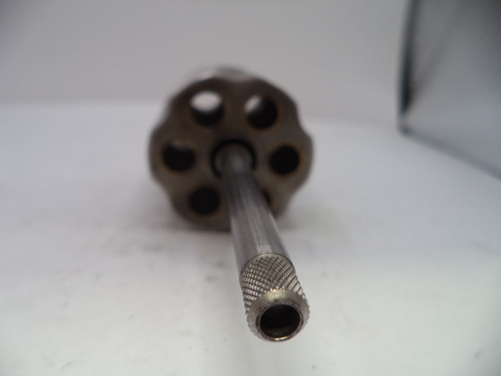 Close-up of a metal cylindrical object with a textured end on a white surface