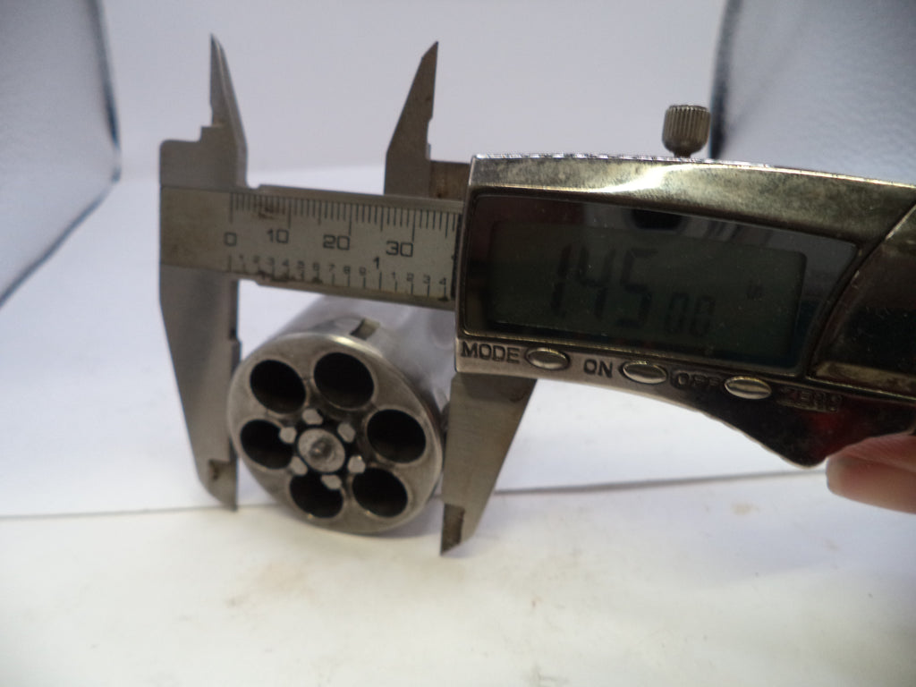 Caliper measuring a metallic cylindrical object against a white background