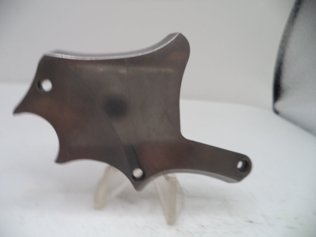 Metallic object on a white surface with a blurred background