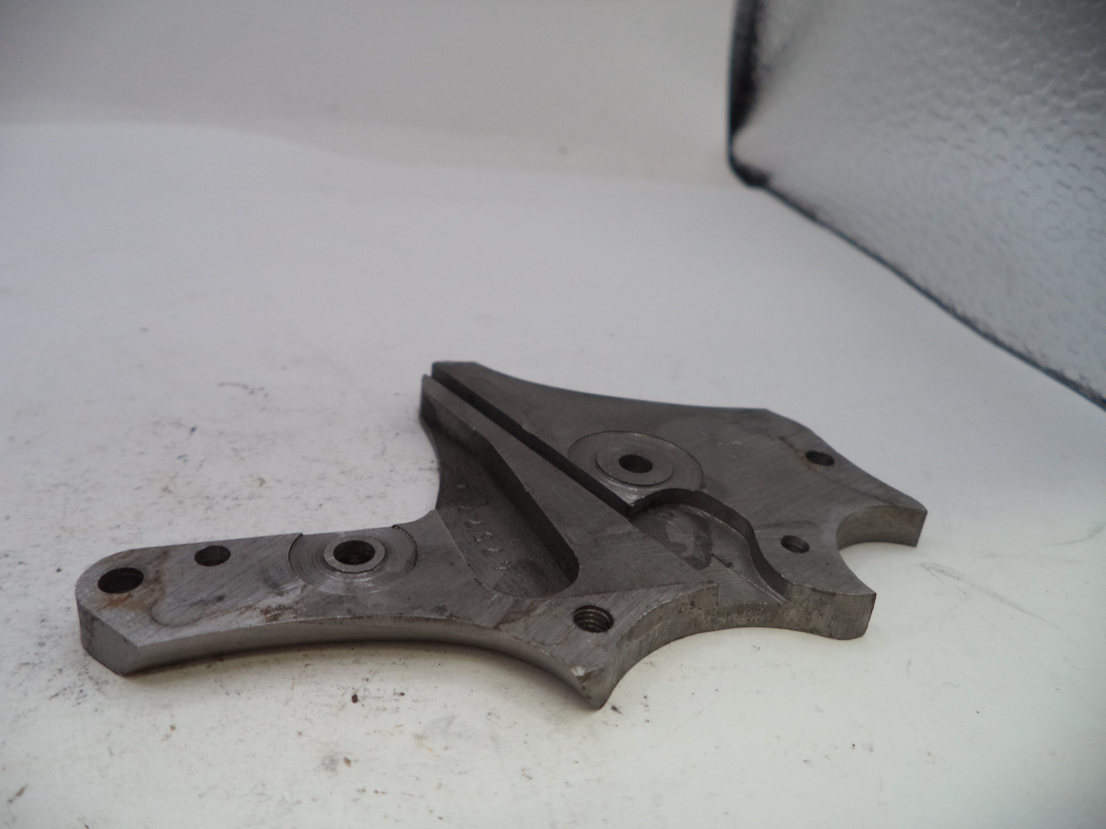 Metal mechanical component on a white surface