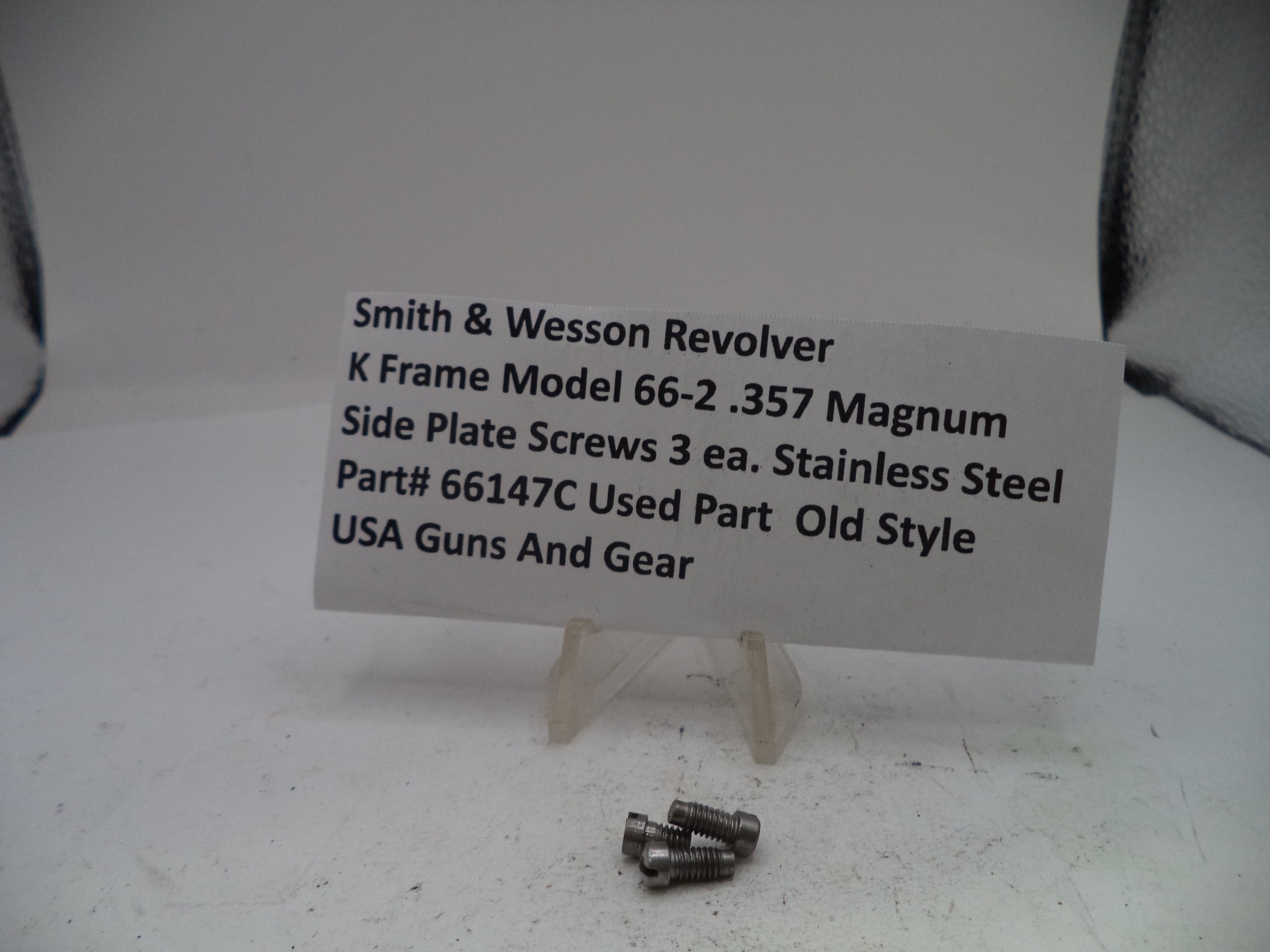 Smith & Wesson revolver side plate screws with a label on a white background
