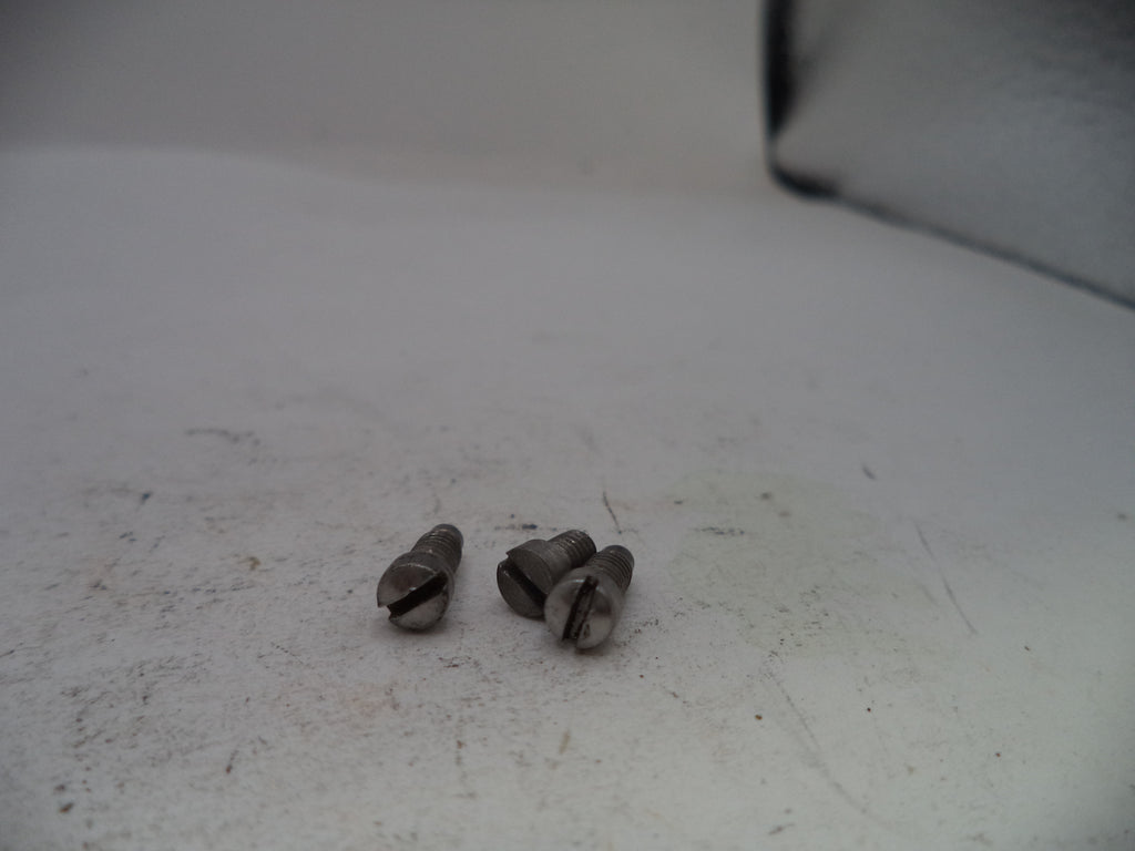 Two small metallic objects on a textured white surface