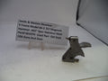 Smith & Wesson revolver part on a white surface with a label