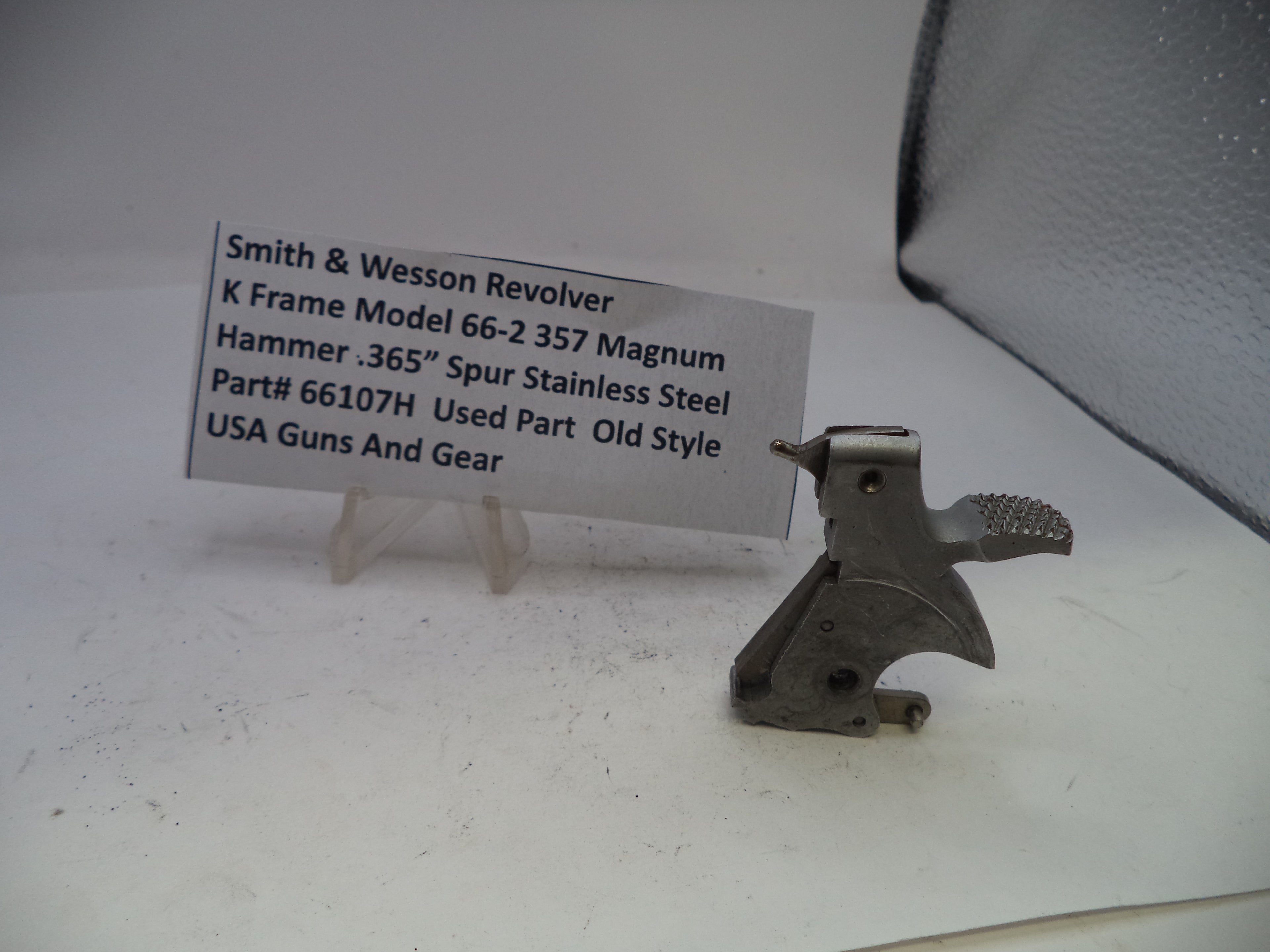 Smith & Wesson revolver part on a white surface with a label