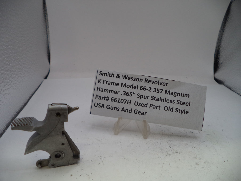 Metal gun part with a label on a white background