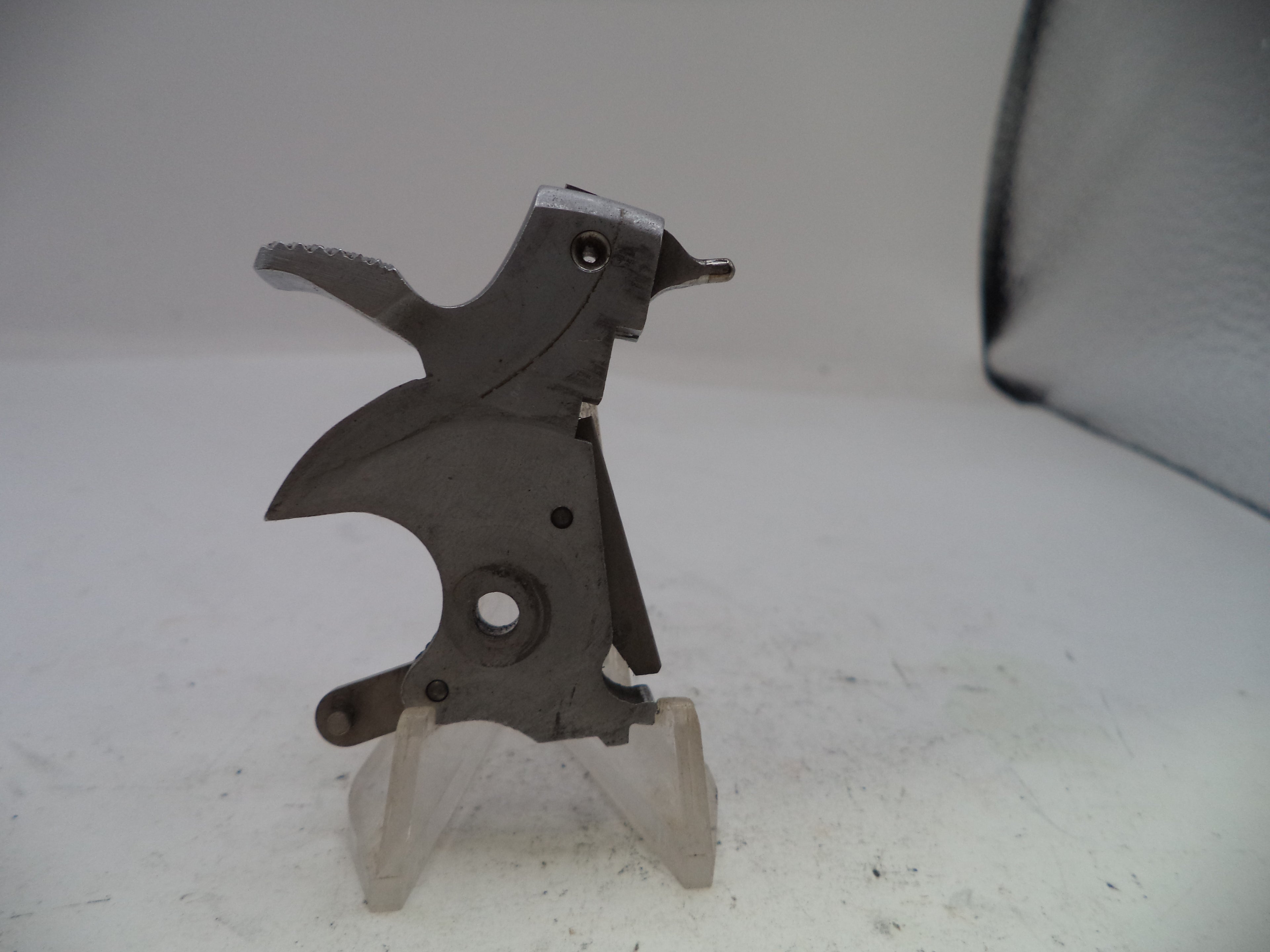 Metal mechanical component on a stand against a white background