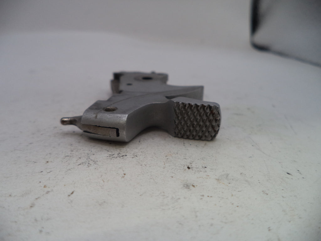 Metal tool with textured grip on a white surface