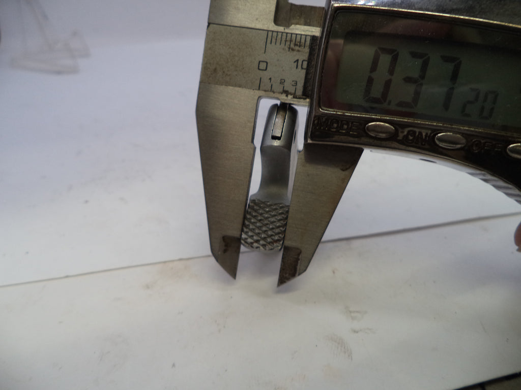Digital caliper measuring a small object on a white background