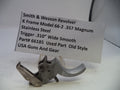 Smith & Wesson revolver part with descriptive card on a white background