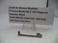 Smith & Wesson revolver hammer block part on a white background with a label.
