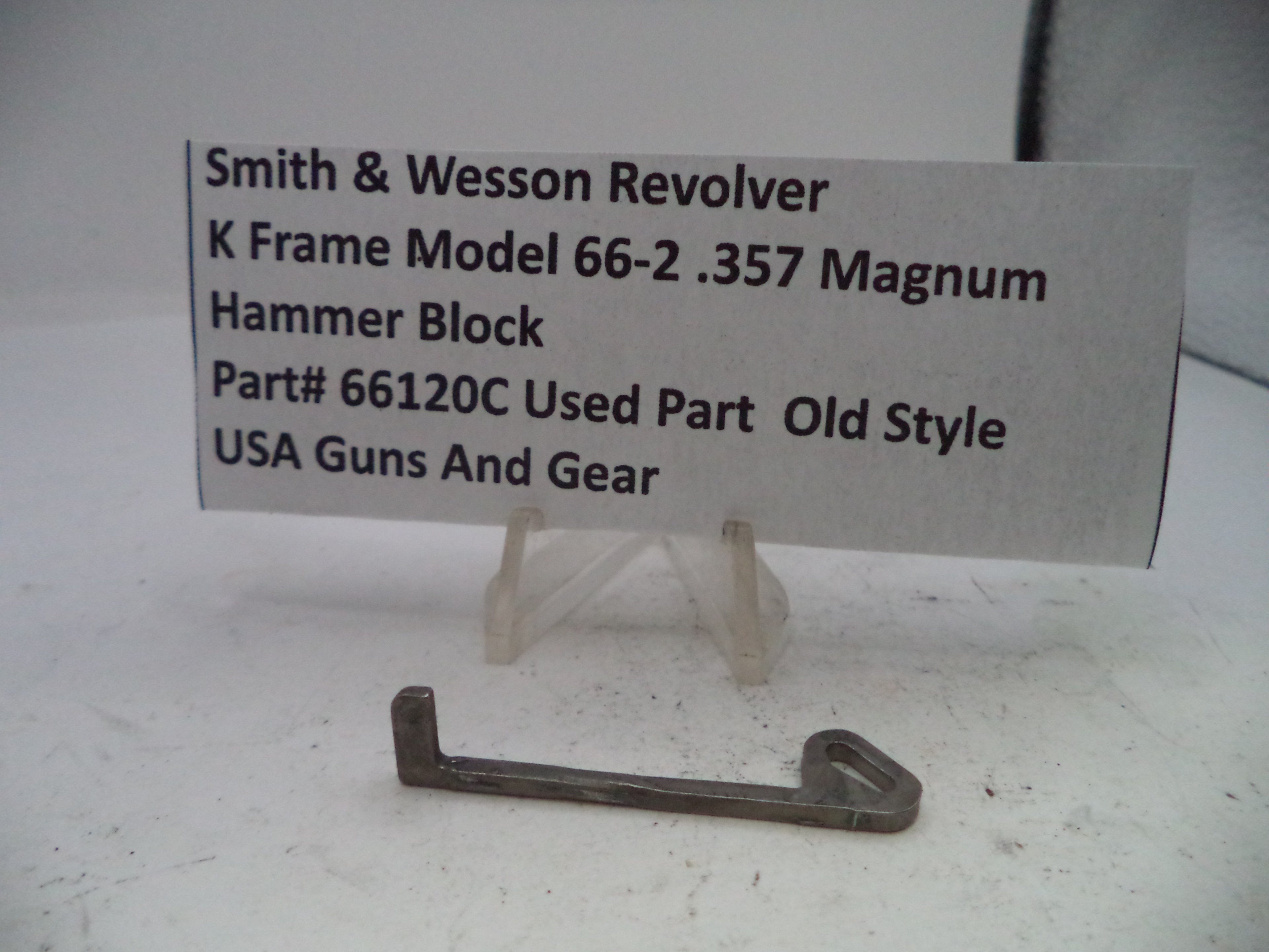Smith & Wesson revolver hammer block part on a white background with a label.