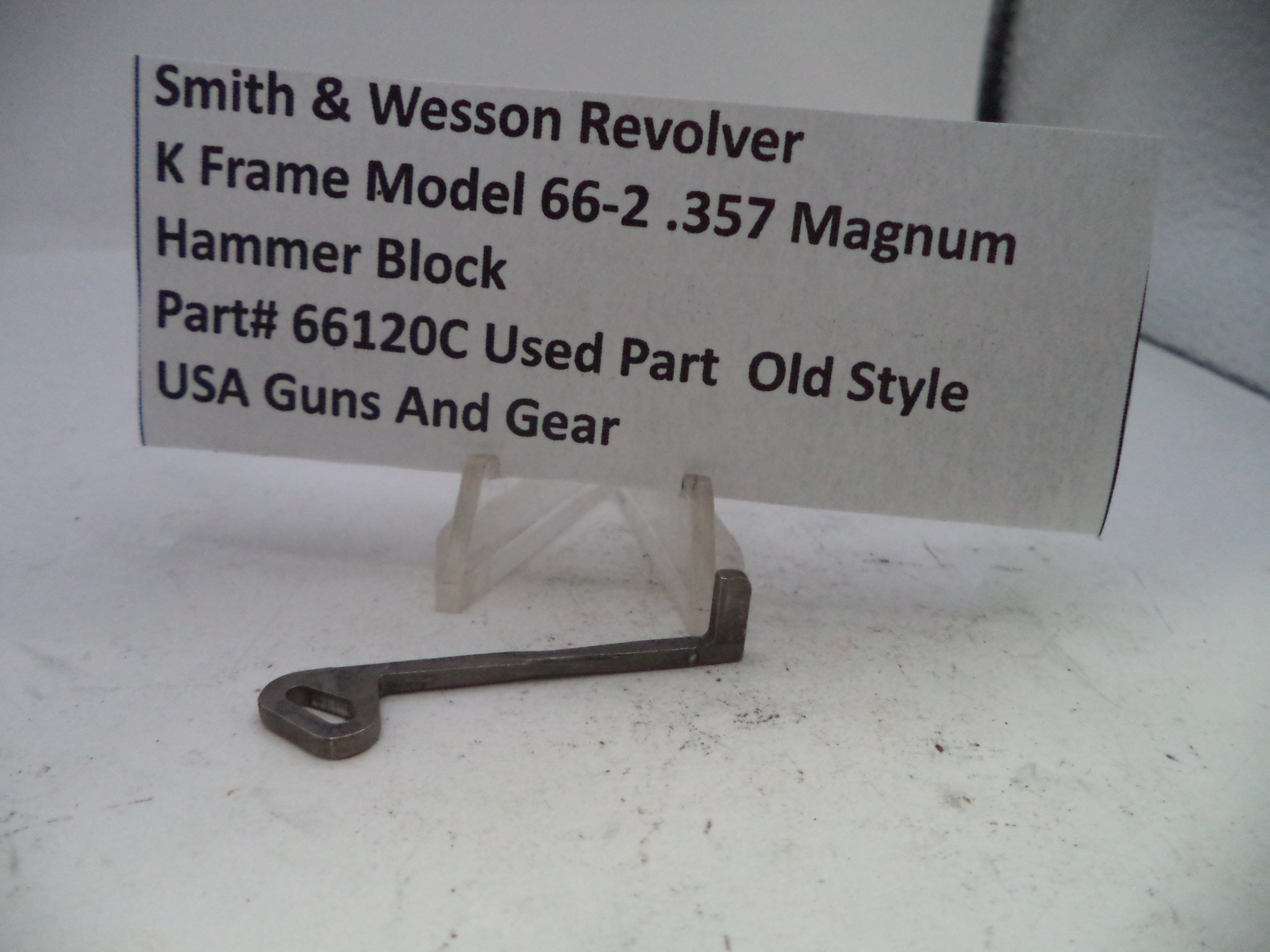 Smith & Wesson revolver hammer block on a stand with a label
