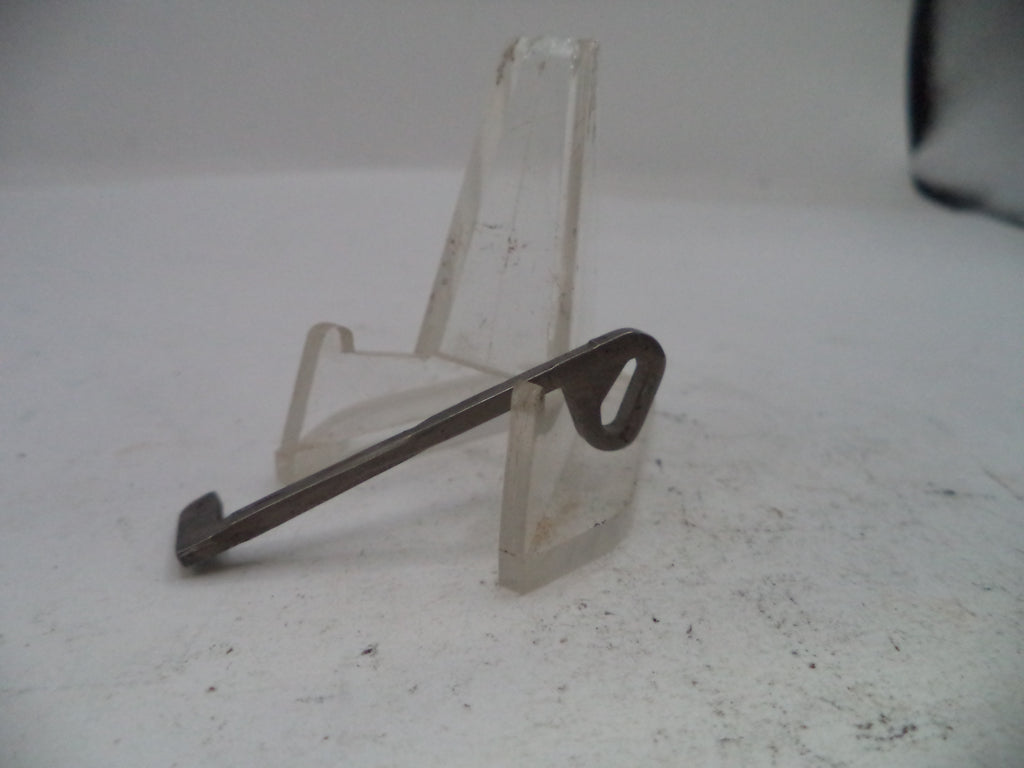Metal key on a stand against a white background