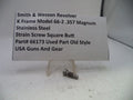Small metal screw with descriptive label on a white background