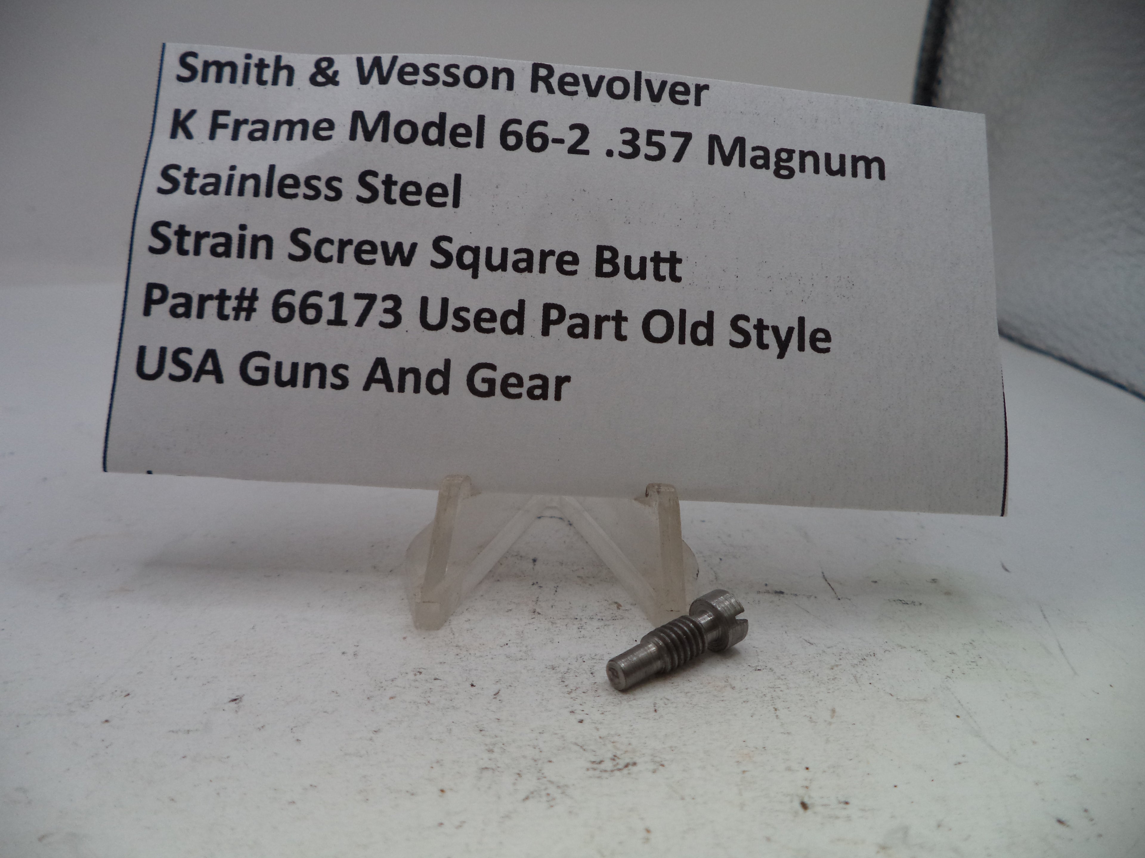 Small metal screw with descriptive card on a white background