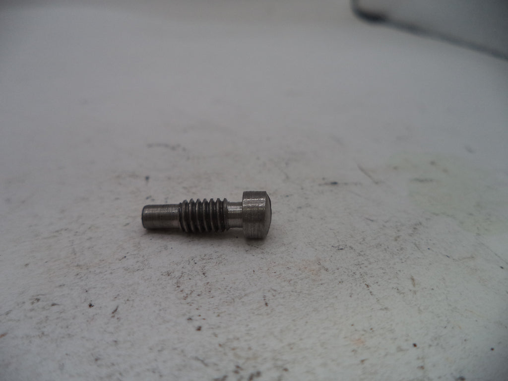 Metal screw on a textured gray surface
